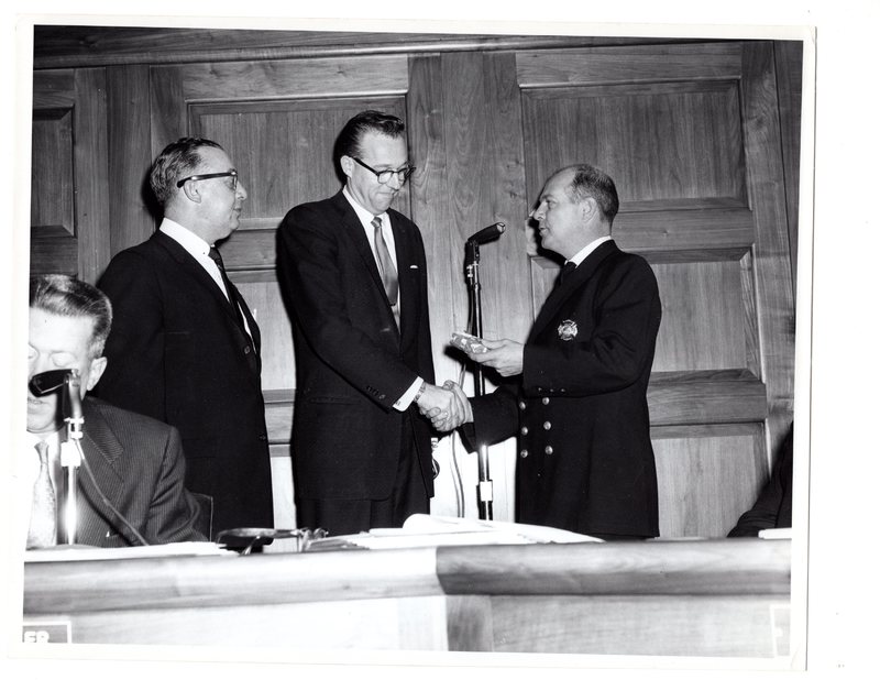 1 black and white photograph (8x10) Mayor Hugh Gillson and member of the fire department at Borough Hall, Jan. 1, 1962.jpg
