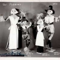 1 black and white photograph 4 pilgrim scarecrows from unnamed event undated.jpg