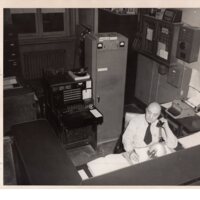 1 black and white photograph 8 x 10 Bergenfield Police officer inside station 1953